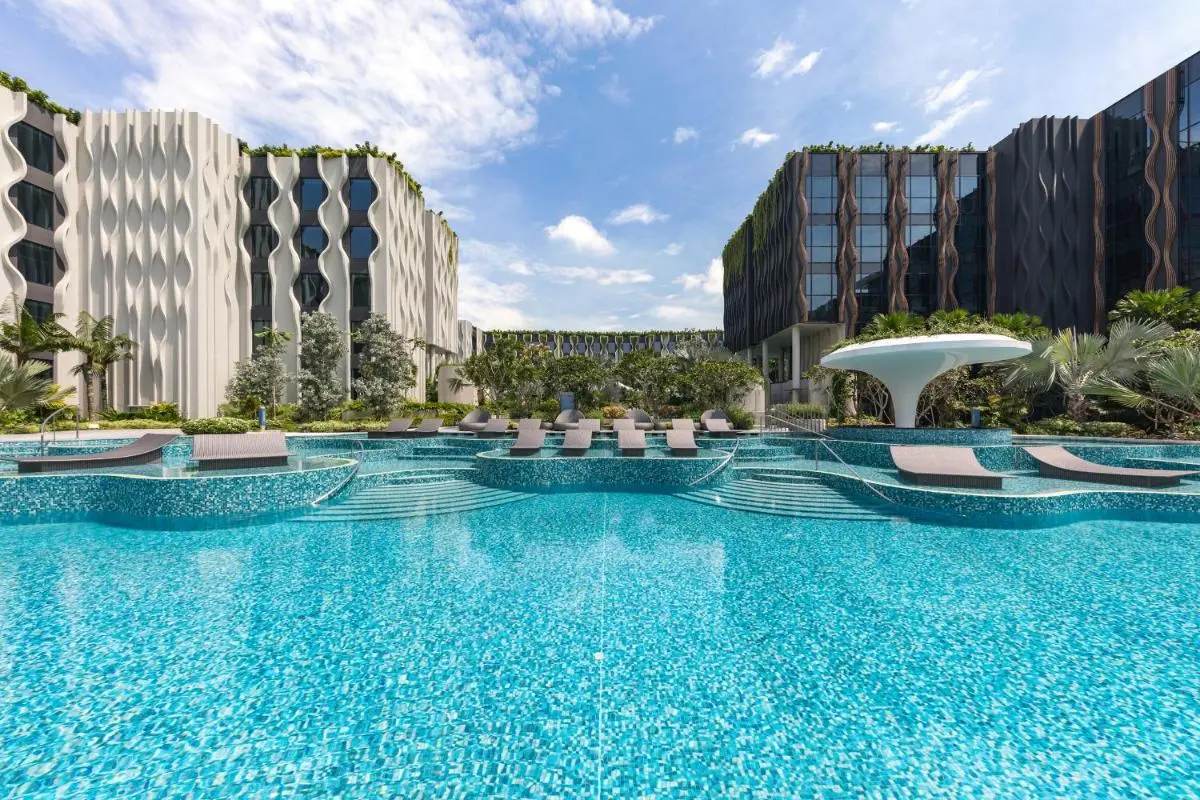 The Barracks Hotel Sentosa by Far East Hospitality Outdoor Swimming Pool Area with Water Features and Greenery on Sentosa Island