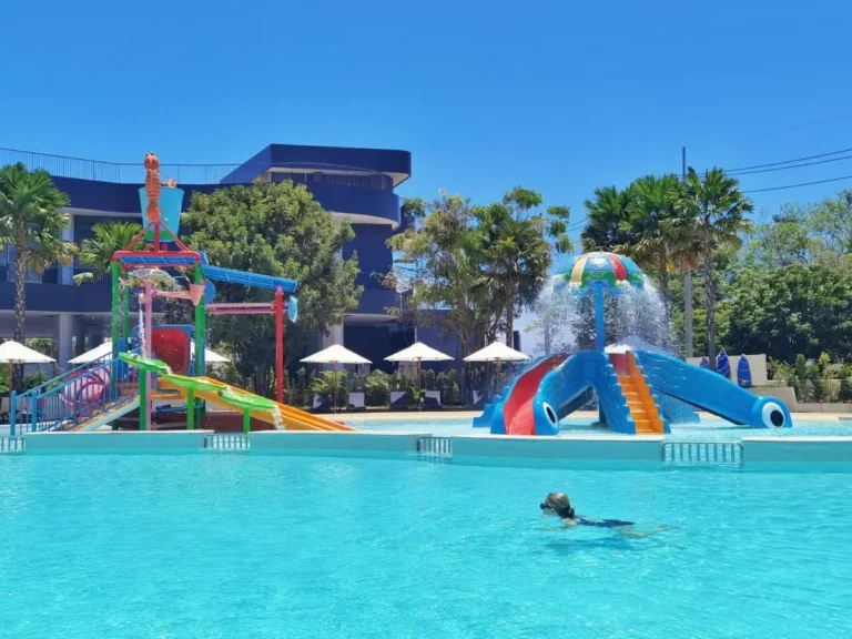 Outdoor Swimming Pool with Colorful Water Slides and Lounge Area at Rawai Beach