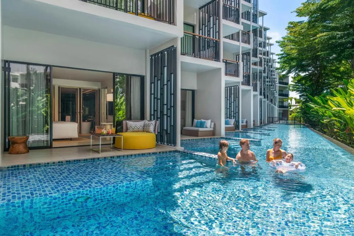 Outdoor Swimming Pool with Direct Patio Access and Lush Greenery at Mai Khao Beach