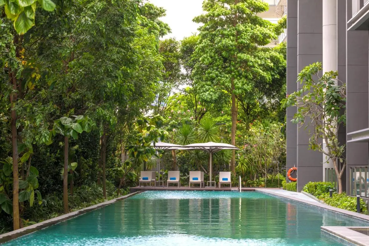 Outdoor Swimming Pool with Lounge Chairs and Shade Umbrellas in Singapore