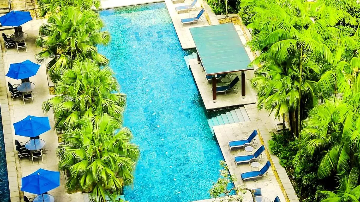 Outdoor Swimming Pool with Lounge Chairs and Shaded Seating in Singapore