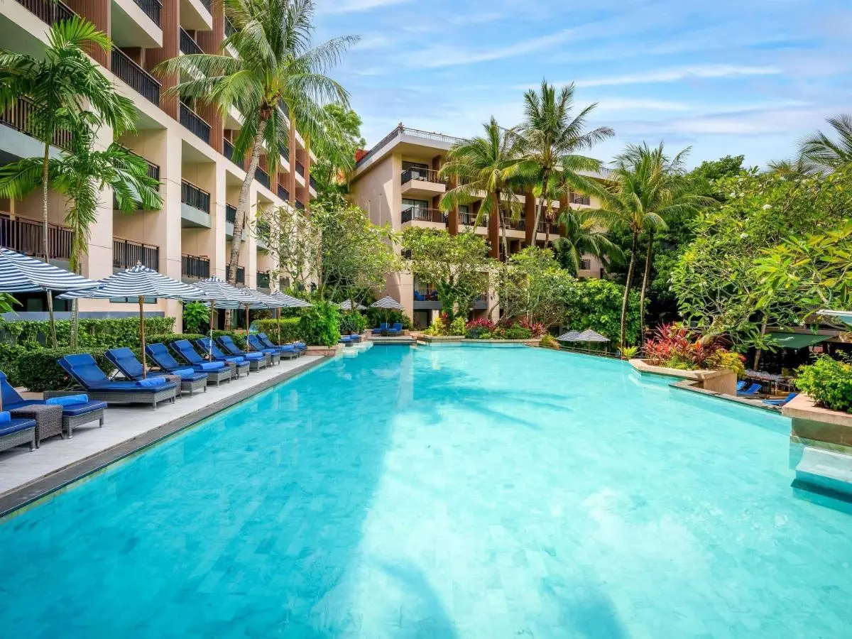 Outdoor Swimming Pool with Lounge Chairs and Tropical Surroundings at Kata Beach