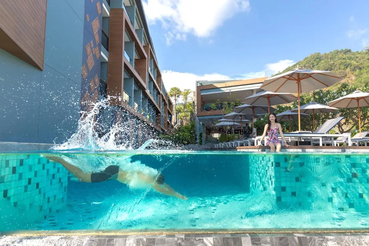 Outdoor Swimming Pool with Lounge Chairs and Umbrellas at Patong Beach