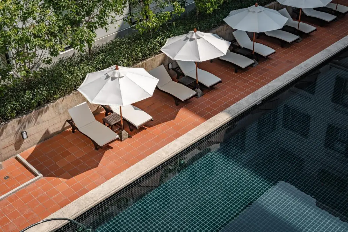 Outdoor Swimming Pool with Lounge Chairs and Umbrellas in Chang Phueak Chiang Mai