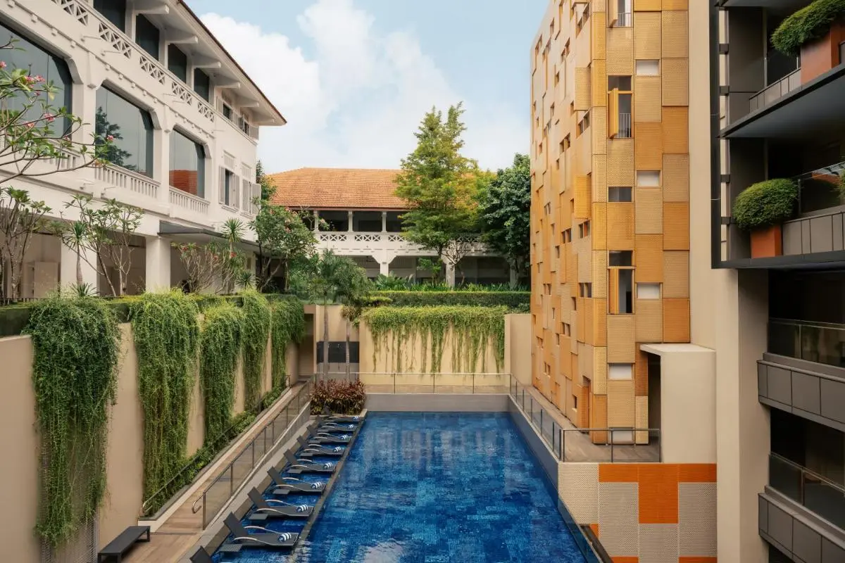 Oasia Resort Sentosa by Far East Hospitality Outdoor Swimming Pool with Lounge Seating and Greenery on Sentosa Island