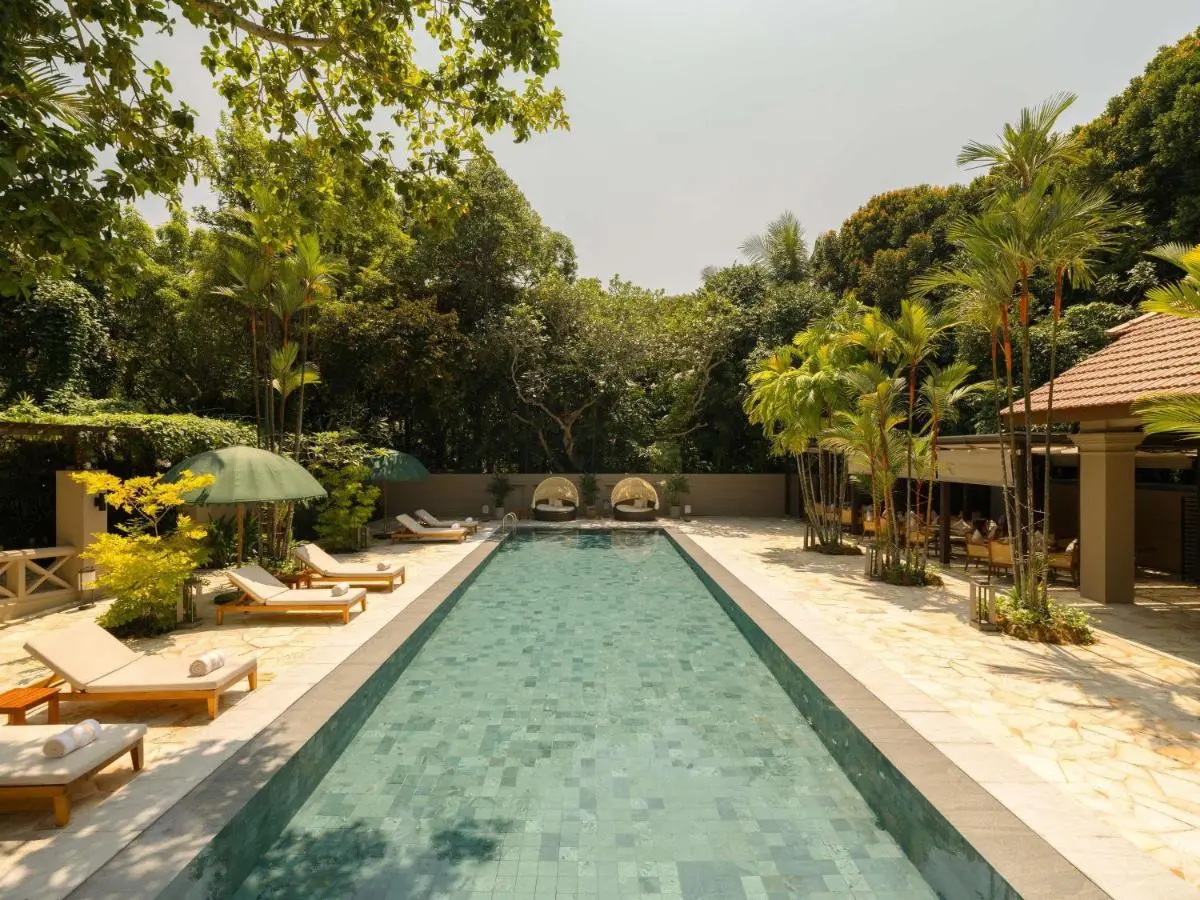 Outdoor Swimming Pool with Lounge Seating and Shaded Areas on Sentosa Island