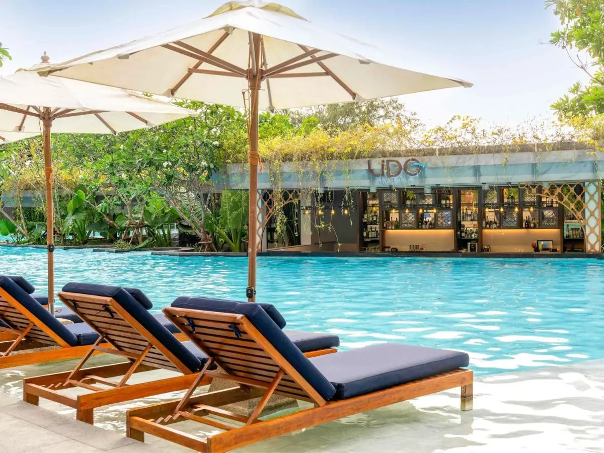 Outdoor Swimming Pool with Submerged Lounge Chairs and Poolside Bar at Karon Beach