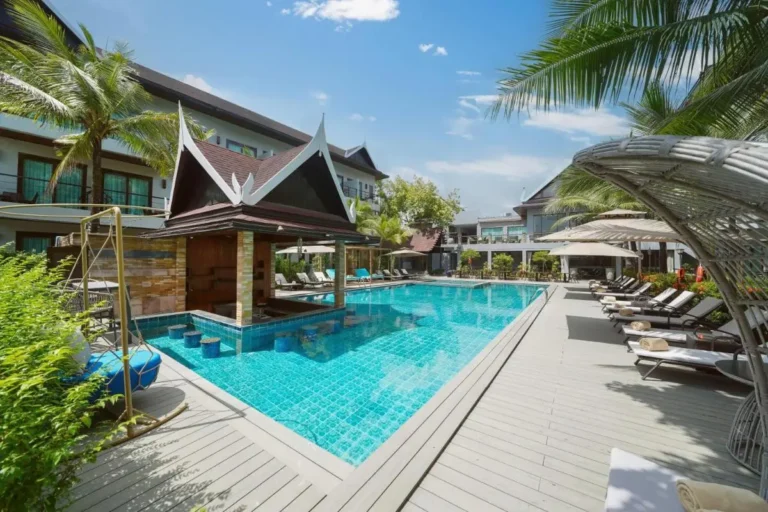 Outdoor Swimming Pool with Swim-Up Bar and Lounge Area in Thalang Resort
