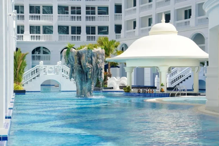 Outdoor Swimming Pool with Swim-Up Bar and Waterfall Feature at Patong Beach Complex