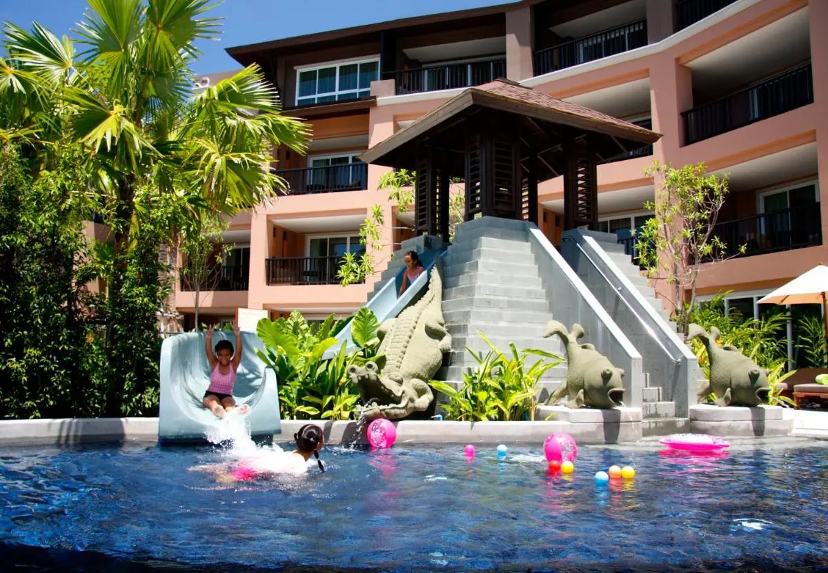 Pullman Phuket Panwa Beach Resort Outdoor Swimming Pool with Water Slide and Tropical Surroundings at Panwa Beach