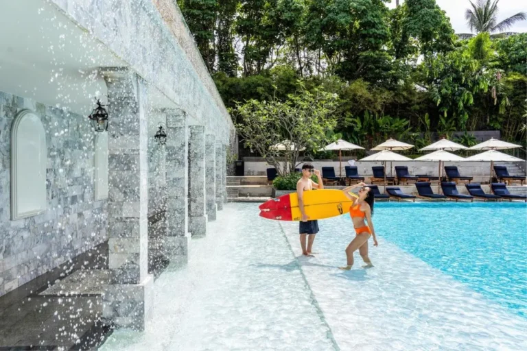 Outdoor Swimming Pool with Waterfall Features and Lounge Area at Karon Beach