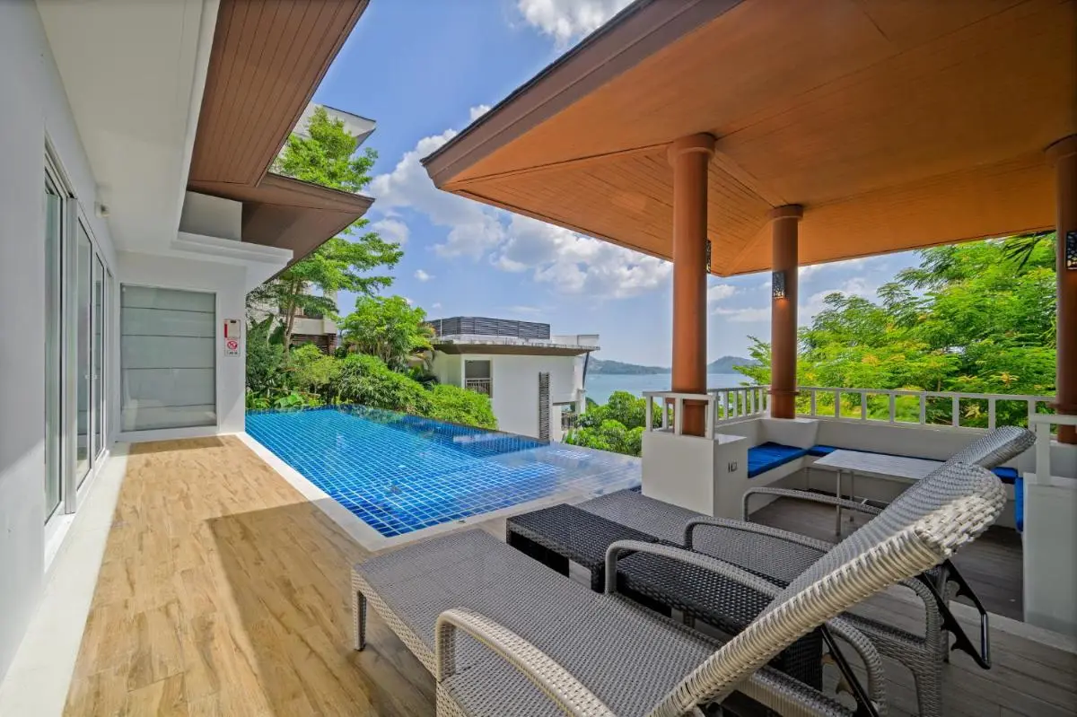 Outdoor Terrace with Infinity Pool and Lounge Area Overlooking Natural Landscape at Patong Beach