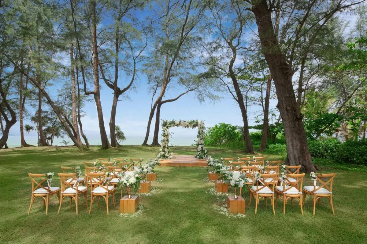 Outdoor Wedding Ceremony Setup with Floral Arch and Waterfront View at Mai Khao Beach