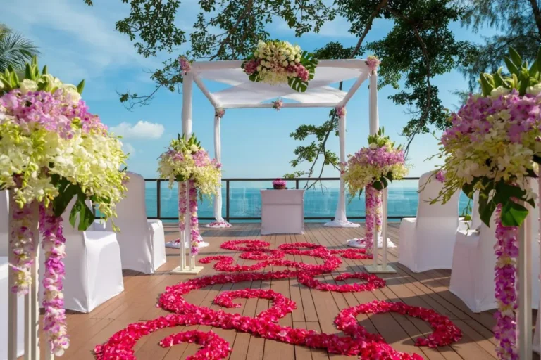 Outdoor Wedding Ceremony Setup with Floral Decor Overlooking Ocean at Nai Thon Beach