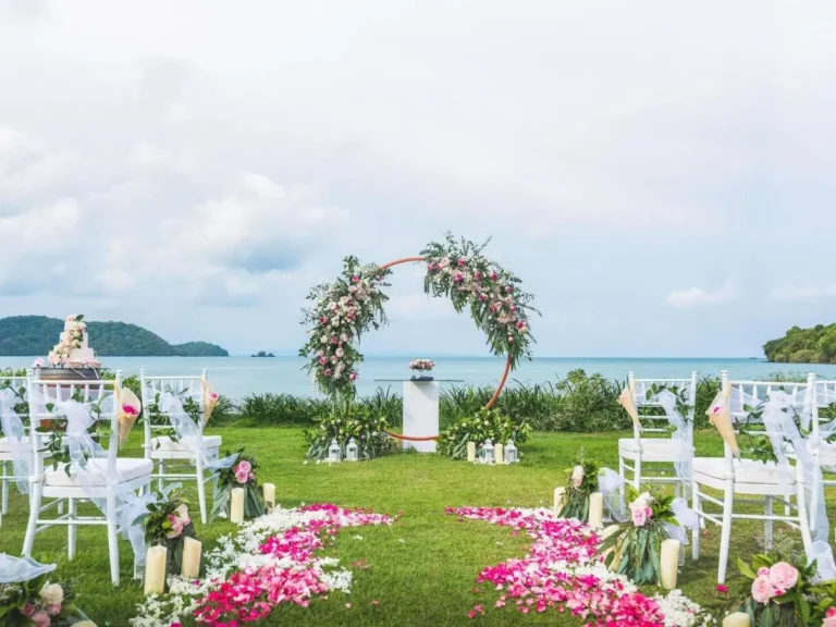 Outdoor Wedding Setup with Floral Arch and Scenic Water View at Panwa Beach