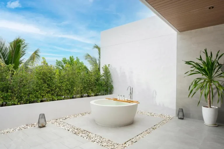 Outdoor Wellness Area Featuring Circular Bathtub and Lush Greenery at Mai Khao Beach