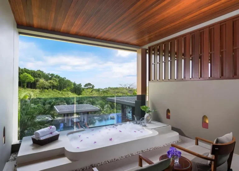 Outdoor Wellness Area with Jacuzzi Tub and Pool Overlooking Lush Greenery at Patong Beach