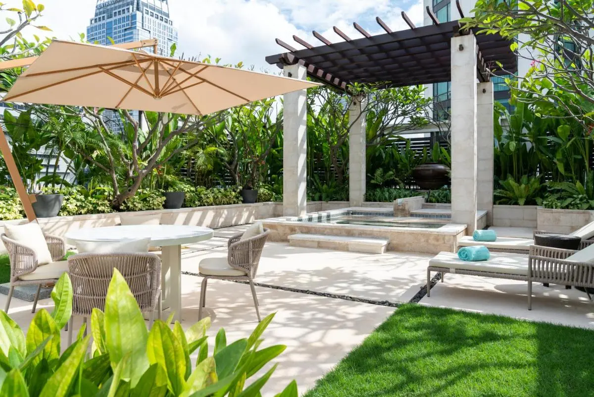 Outdoor Wellness Area with Pool, Lounge Chairs, and Pergola in Pathumwan Bangkok