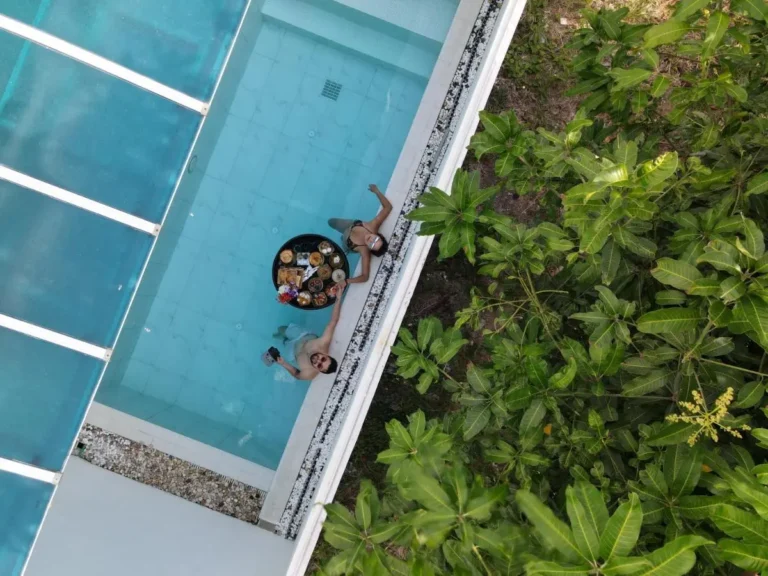 Overhead View of Rectangular Swimming Pool with Floating Tray and Greenery at Rawai Beach