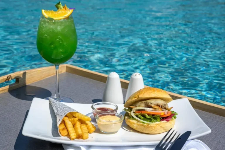 Poolside Meal Featuring Cheeseburger Fries and Refreshing Drink at Patong Beach