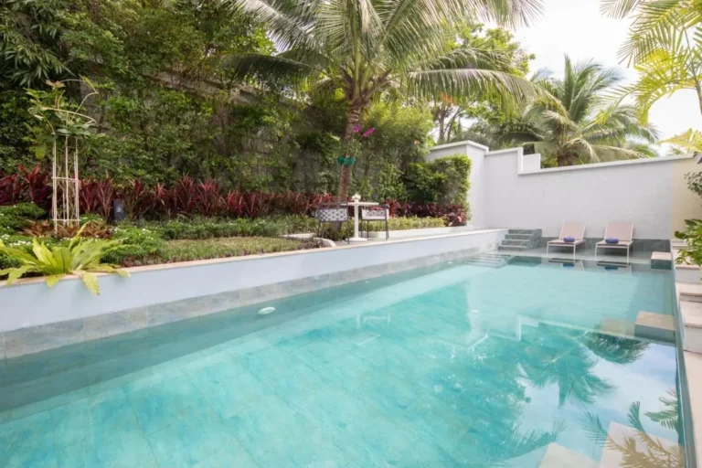 Private Outdoor Swimming Pool with Lounge Chairs and Tropical Garden in Phuket Town