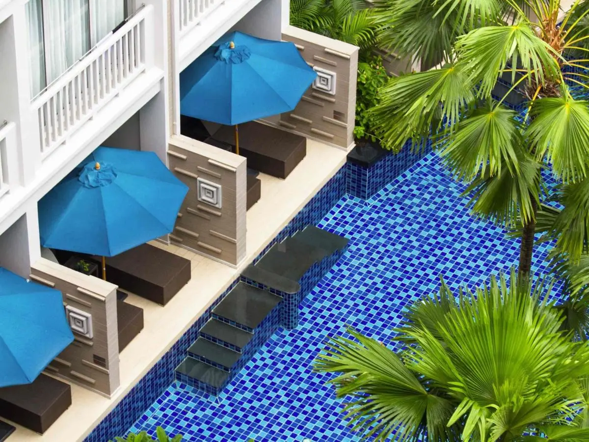Private Pool Area with Blue Mosaic Tiles and Shaded Seating Alcoves at Patong Beach
