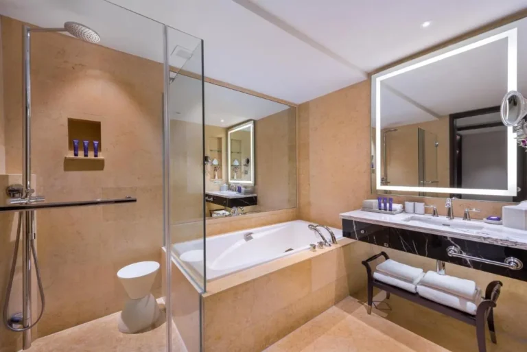 Rectangular Bathtub and Glass-Enclosed Shower Area with Rain Showerhead in Marina Bay Bathroom