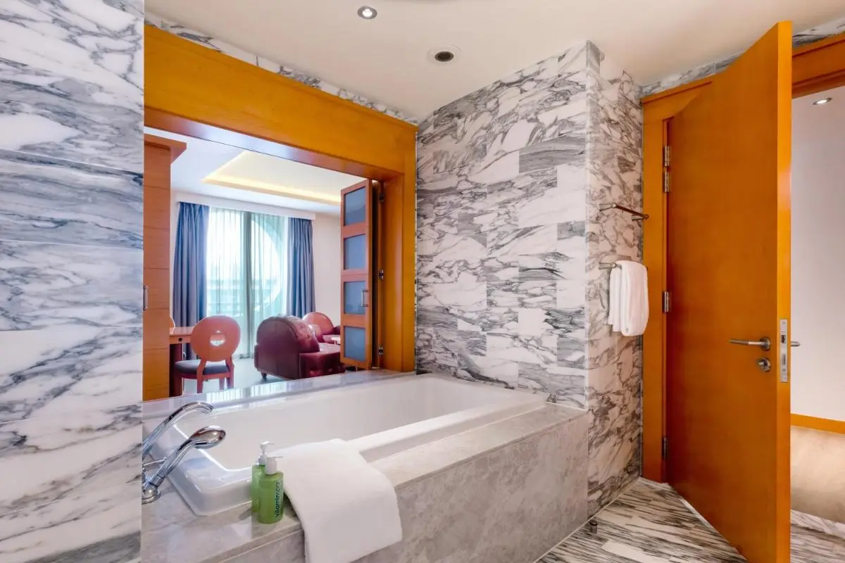 Rectangular Bathtub with Marble Surround and Open Living Area in Singapore
