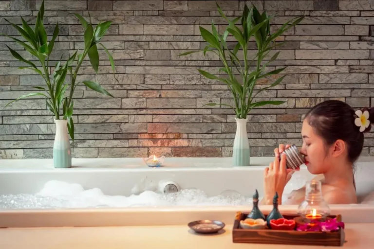 Relaxing Indoor Whirlpool Bathtub with Plants and Candles in Wattana Spa Room