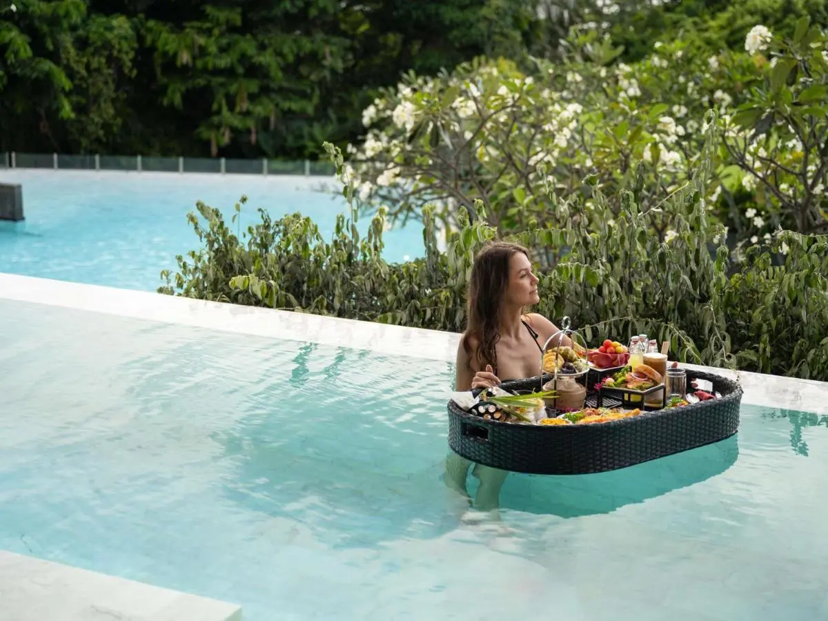 Relaxing Infinity Pool Experience with Floating Tray and Natural Surroundings at Karon Beach