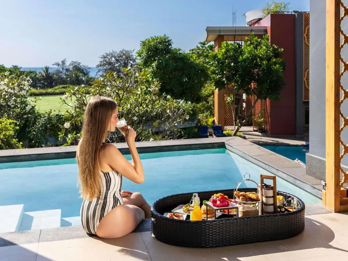 Avista Grande Phuket Karon - MGallery Relaxing Outdoor Pool Area with Breakfast Tray and Ocean View at Karon Beach Phuket Province