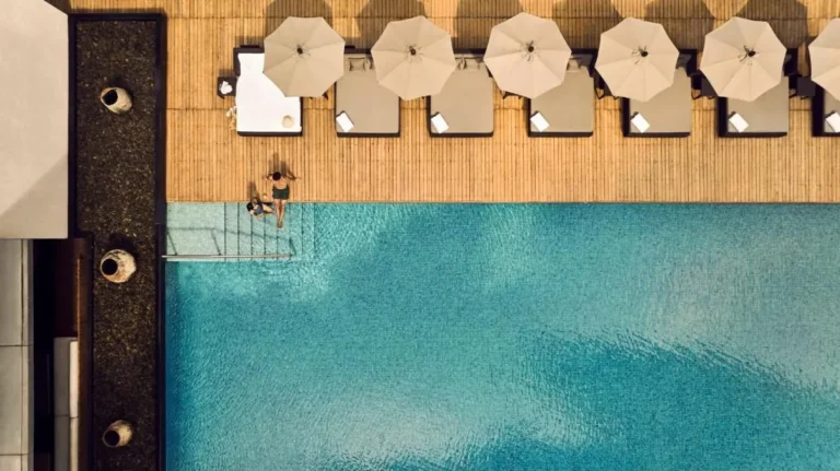 Relaxing Outdoor Swimming Pool and Lounge Area with Umbrellas in Sathorn Bangkok