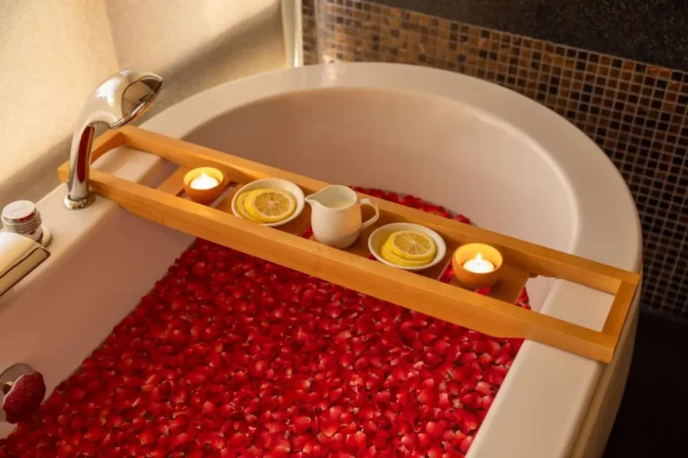 Relaxing Oval Bathtub with Rose Petals and Candlelight in Sathorn Bathroom
