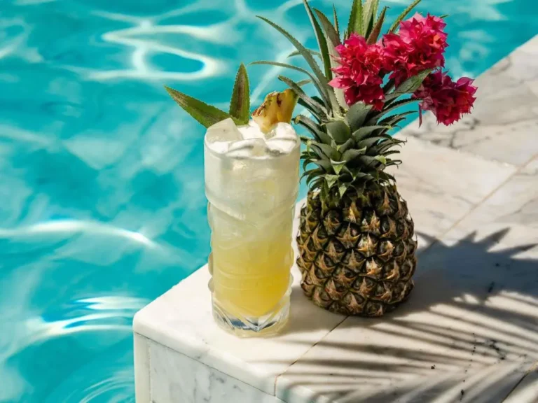 Relaxing Poolside Scene with Refreshing Pineapple Drink at Kata Beach