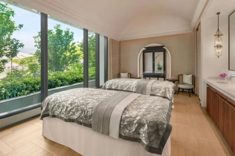 Relaxing Spa Treatment Room with Massage Tables and Natural Light in Pathumwan