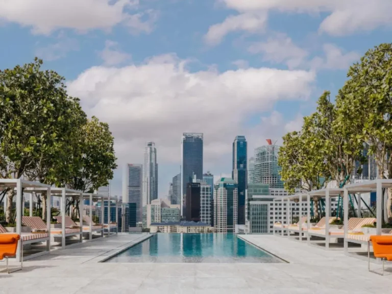 Rooftop Infinity Pool and Lounge Area with City Skyline View in Chinatown Singapore