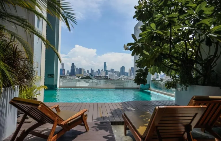 Rooftop Infinity Pool and Lounge Area with City Skyline Views in Bang Kho Laem