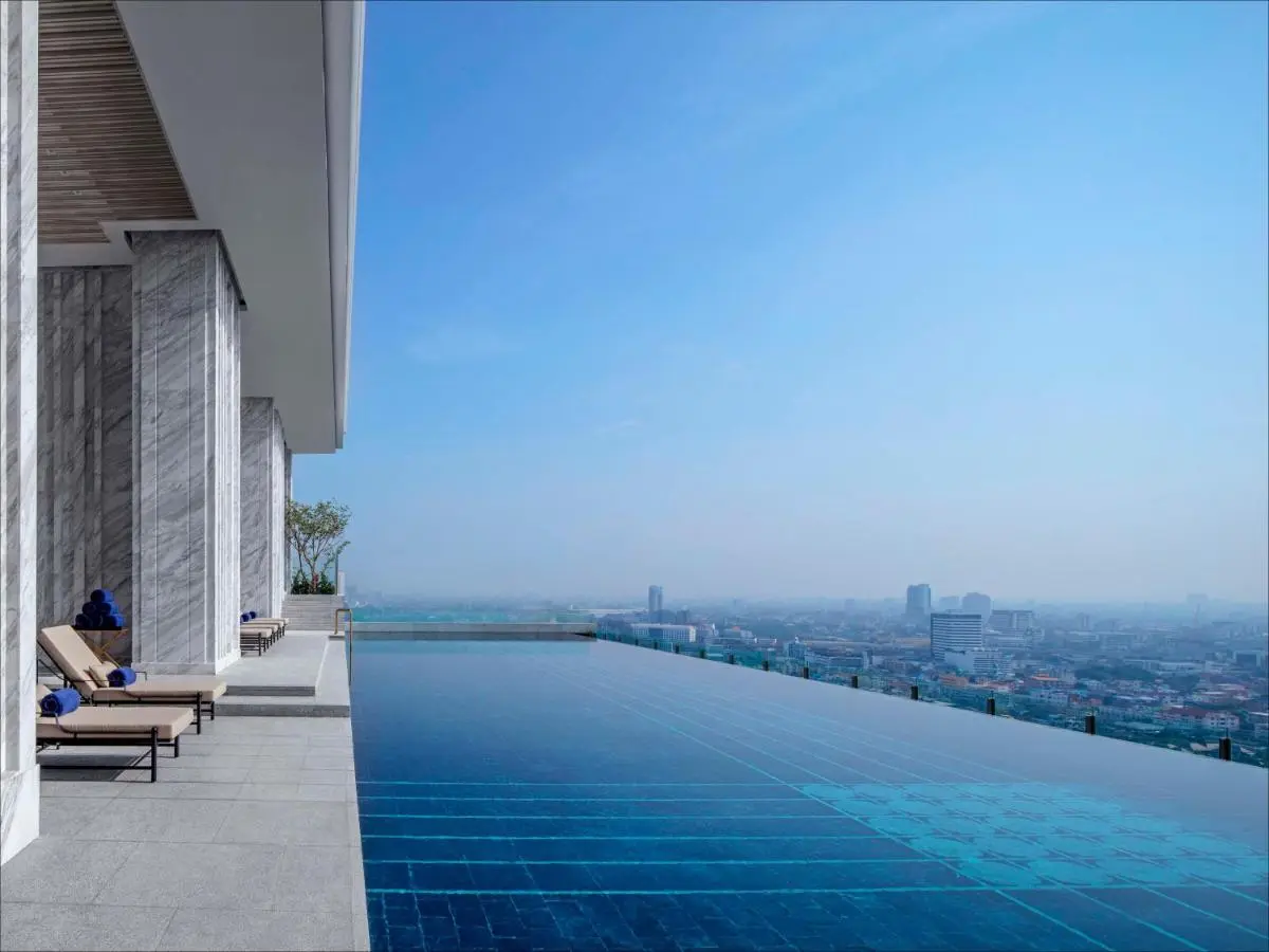 Rooftop Infinity Pool and Lounge Area with City Views in Wattana Bangkok