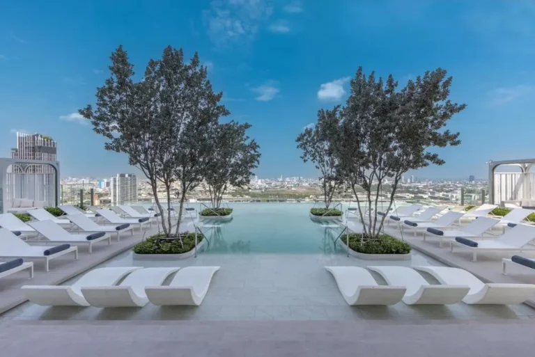 Rooftop Infinity Pool and Lounge Area with Urban Views in Ratchathewi Bangkok
