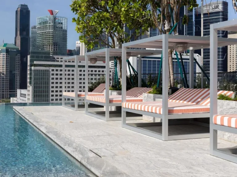 Rooftop Infinity Pool Area with Lounge Beds and Urban Views in Chinatown Singapore