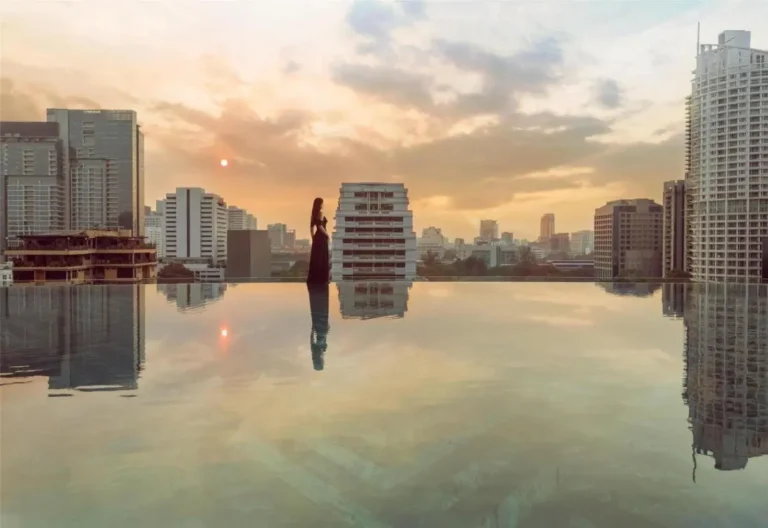 Rooftop Infinity Pool at Sunset Overlooking Pathumwan Urban Skyline in Bangkok