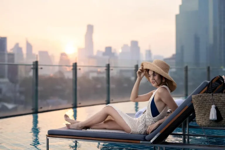 Rooftop Infinity Pool with City Skyline Views and Lounge Seating in Khlong San Bangkok