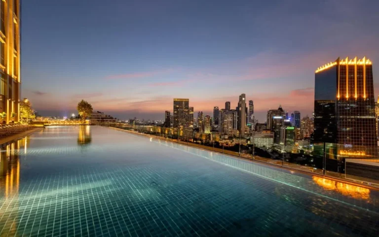 Rooftop Infinity Pool with City Skyline Views and Lounge Seating in Sathorn Bangkok
