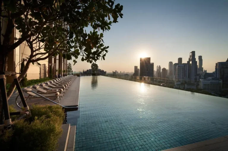 Rooftop Infinity Pool with City Skyline Views and Lounge Seating in Sathorn Bangkok