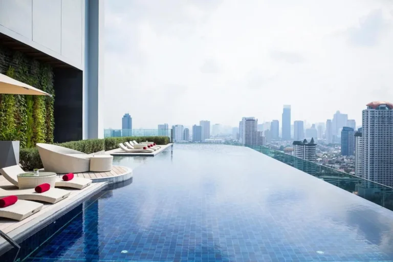 Rooftop Infinity Pool with City Views and Lounge Seating in Thonburi Bangkok