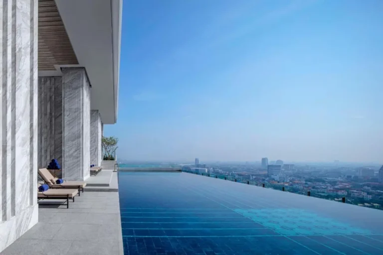 Rooftop Infinity Pool with Cityscape Views and Lounge Area in Wattana Bangkok