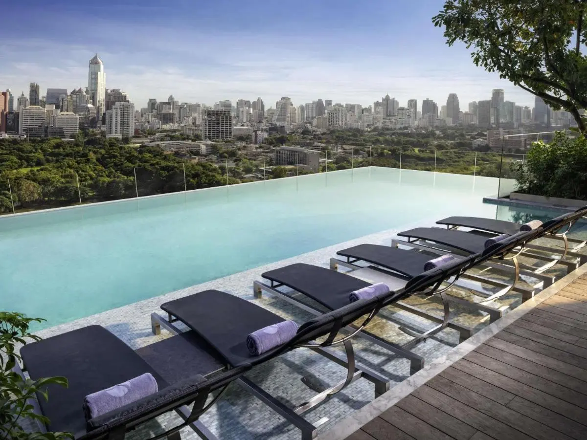 Rooftop Infinity Pool with Lounge Chairs and City Views in Bang Rak Bangkok