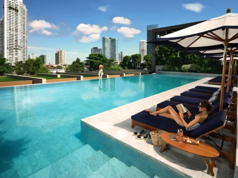 Rooftop Infinity Pool with Lounge Chairs and Cityscape Views in Sathorn Bangkok