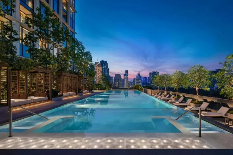 Rooftop Infinity Pool with Lounge Seating and City Views in Pathumwan Bangkok