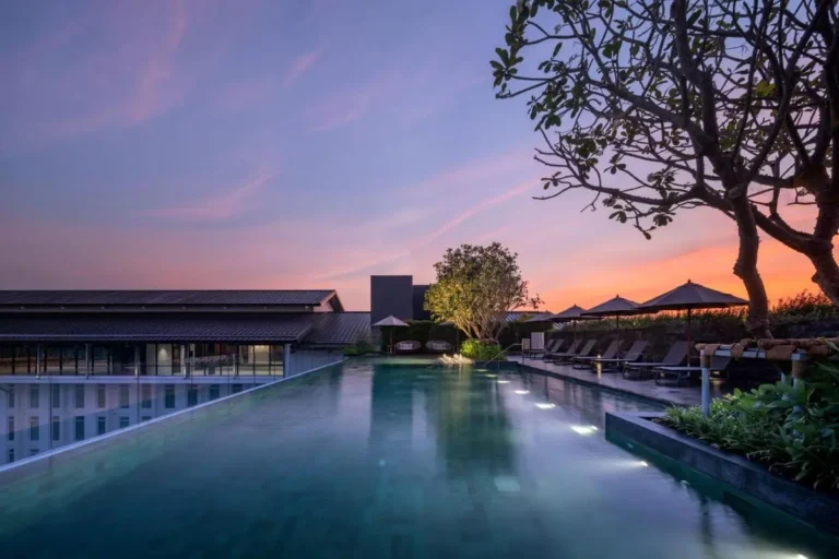 Rooftop Infinity Pool with Lounge Seating and Scenic Twilight Views in Phuket Town